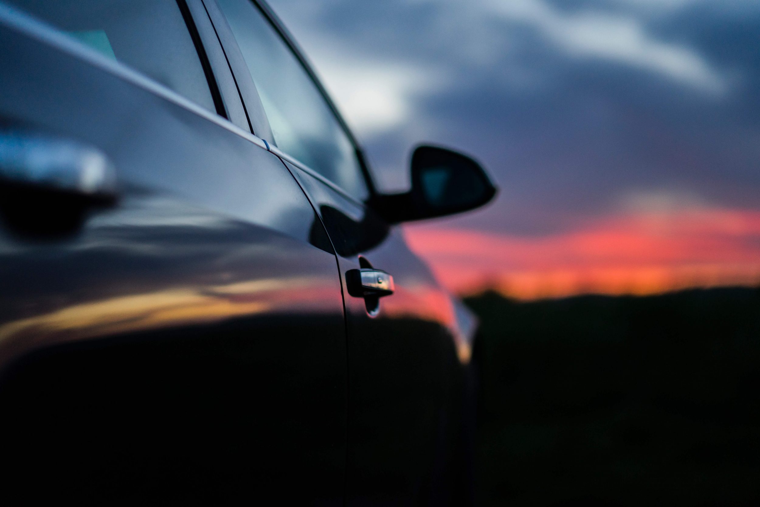 Car on a road in Iceland at sunset