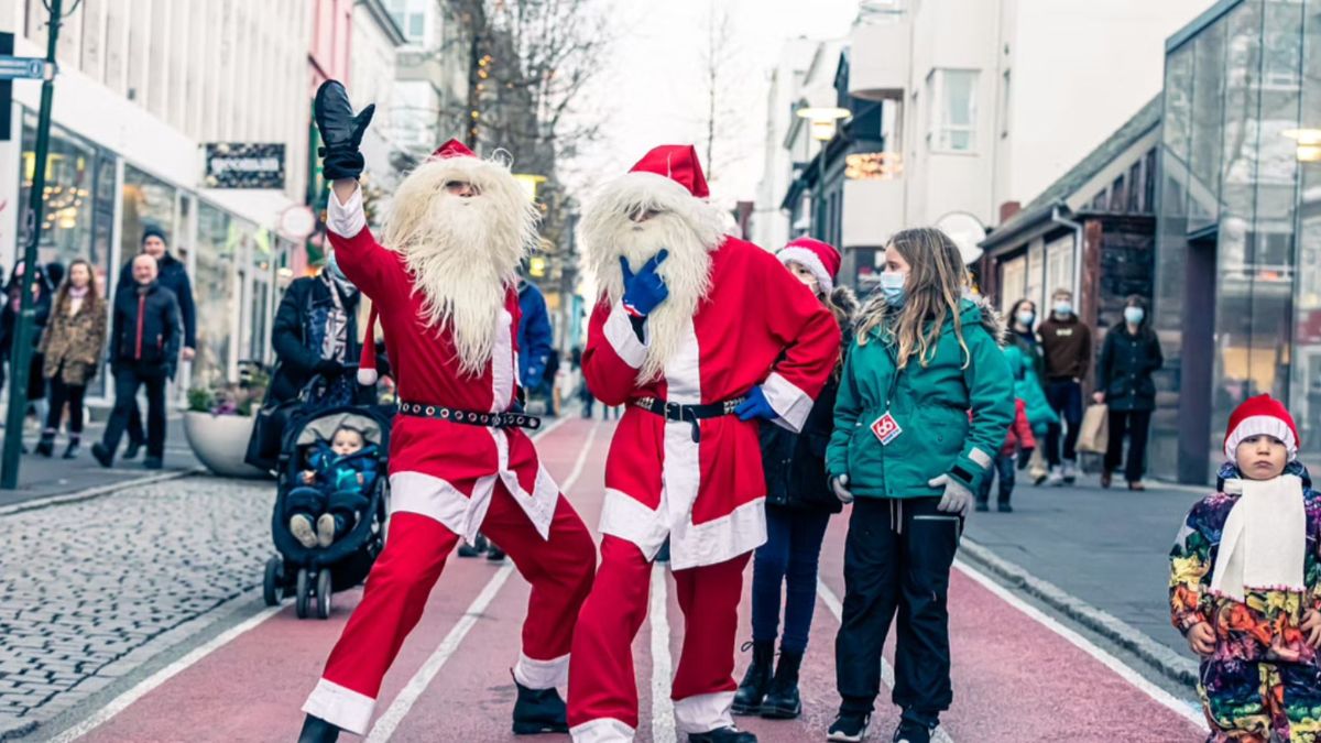 Santa-style Christmas characters walking along a Reykjavík shopping street in December